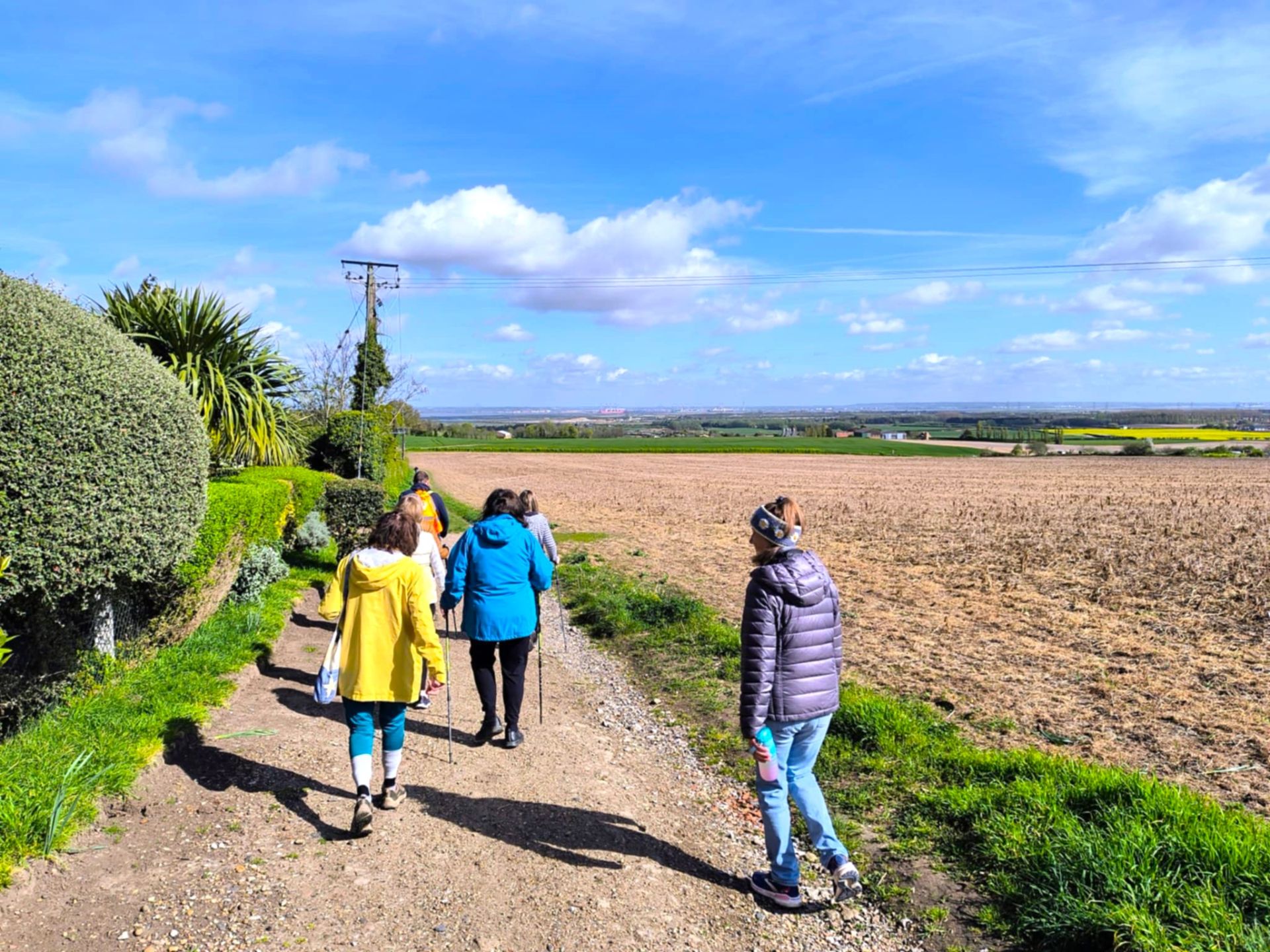 walkers walking along a footpath towards a river